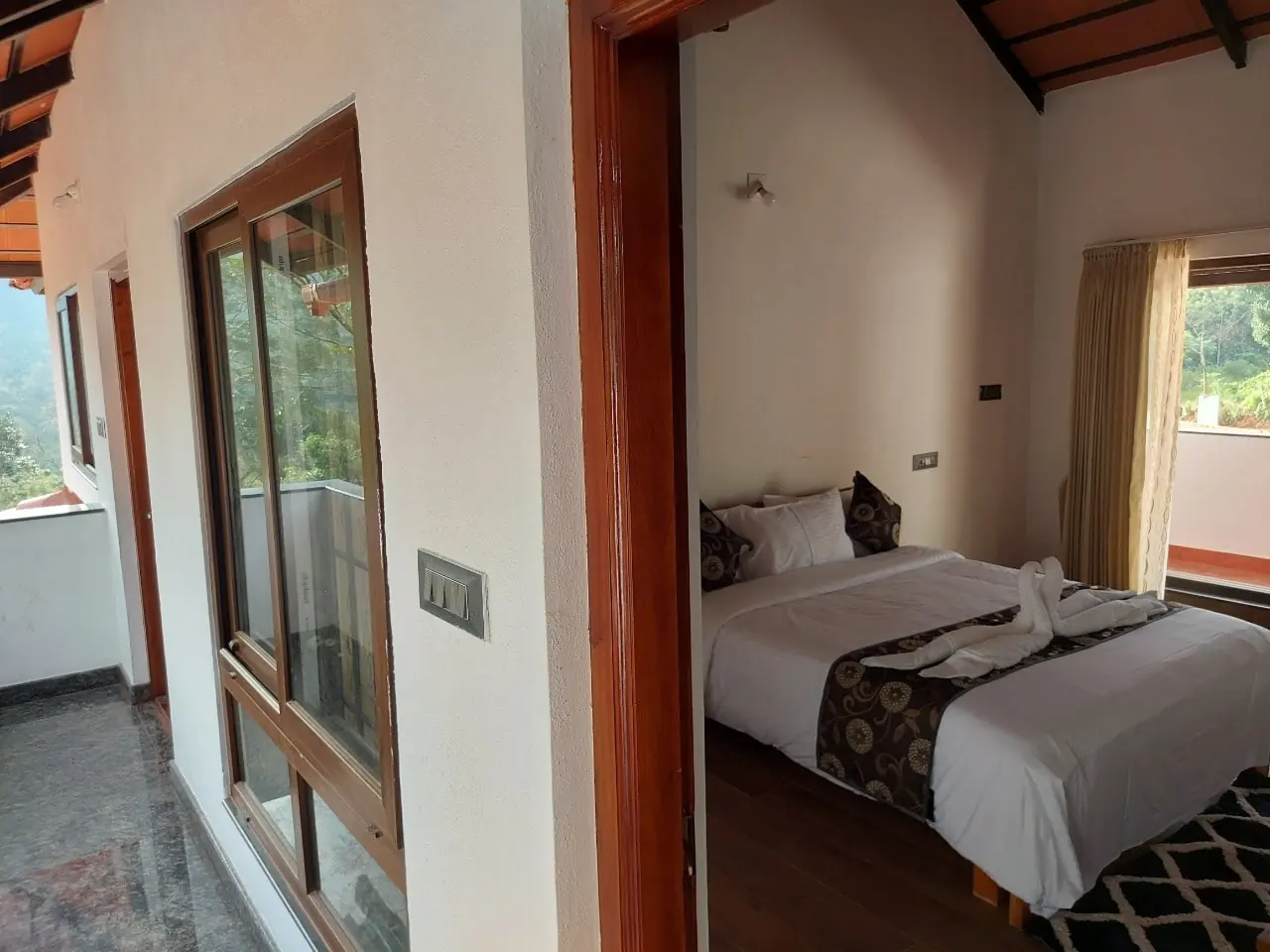 Bedroom with balcony and forest view